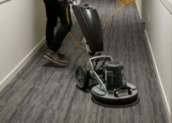 How does carpet cleaning improve long-term fiber durability?